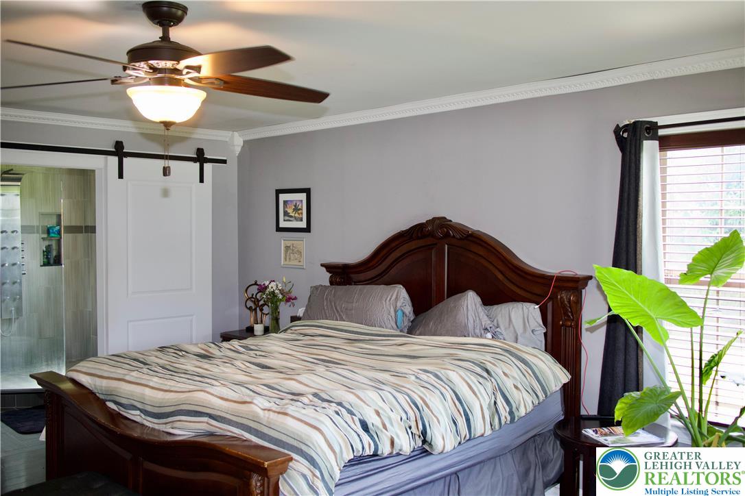 101 Cider Mill Road Mertztown, PA 19539 - Photo 21 of 26 a bedroom with a bed and ceiling fan