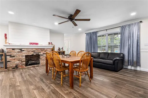 a living room with furniture a fireplace and a window