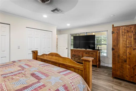 a en suite bathroom with a granite countertop toilet sink and mirror