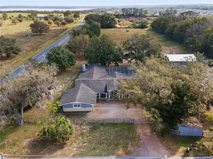 an aerial view of a house with a yard