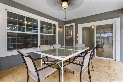 a view of a house with backyard porch and sitting area