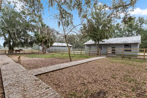 a front view of a house with a yard fountain and fountain in middle