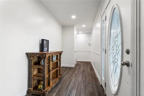a view of a hallway with wooden floor