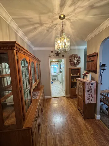 a view of a dining room with furniture wooden floor and chandelier