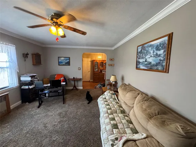 a living room with furniture and a chandelier