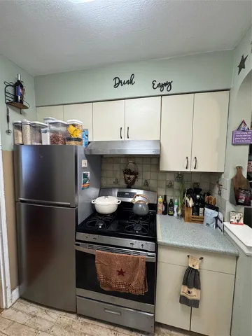 a kitchen with a stove and a refrigerator