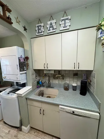 a kitchen with a sink and cabinets