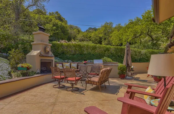 a view of a patio with table and chairs and potted plants