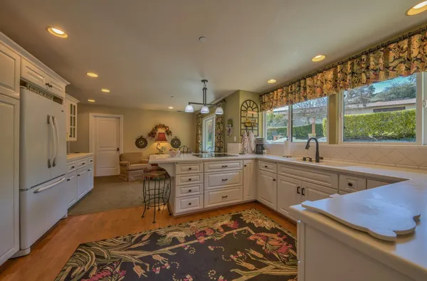 a spacious bedroom with a bed and a dresser