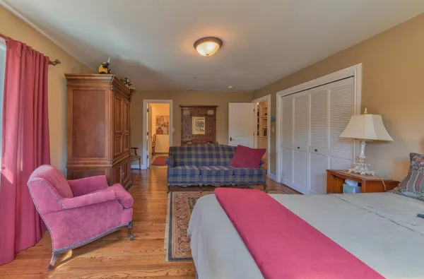 a bathroom with a granite countertop sink a toilet and a mirror