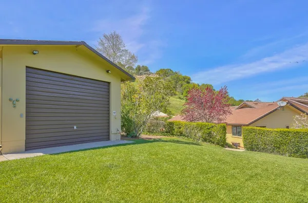 a view of deck with furniture and umbrella