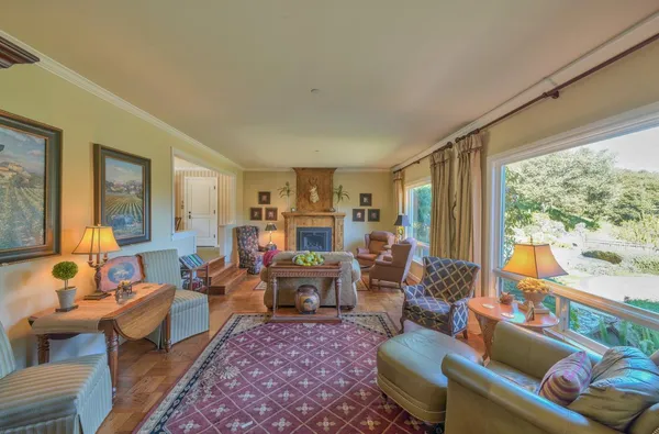 a living room with furniture large window and a table