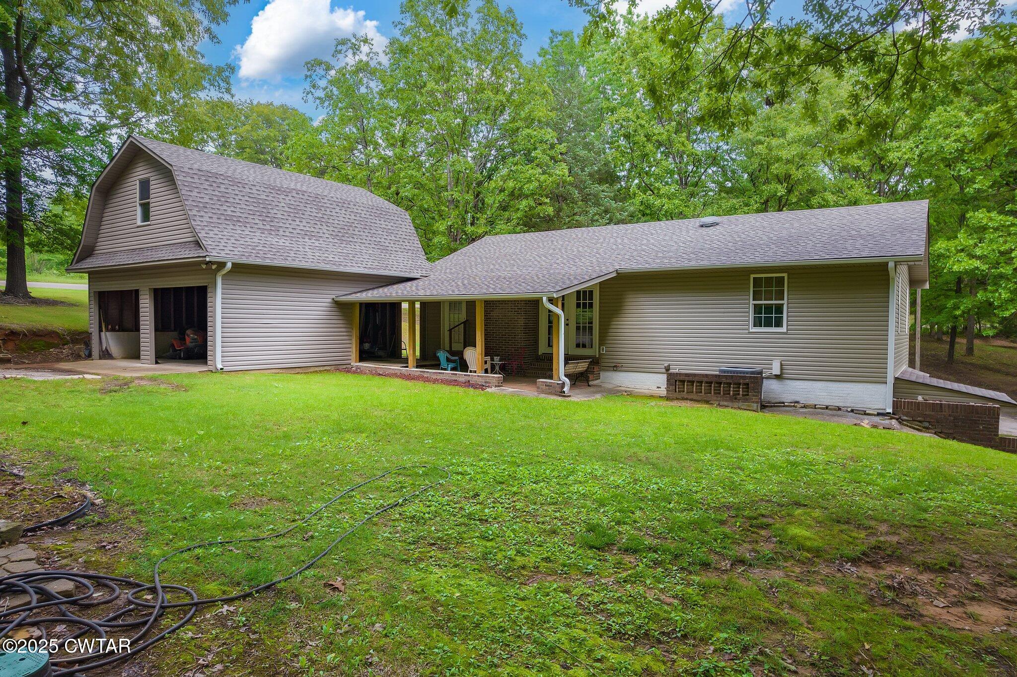 480 Roby Road Reagan, TN 38368 - Photo 26 of 38 a front view of a house with a garden
