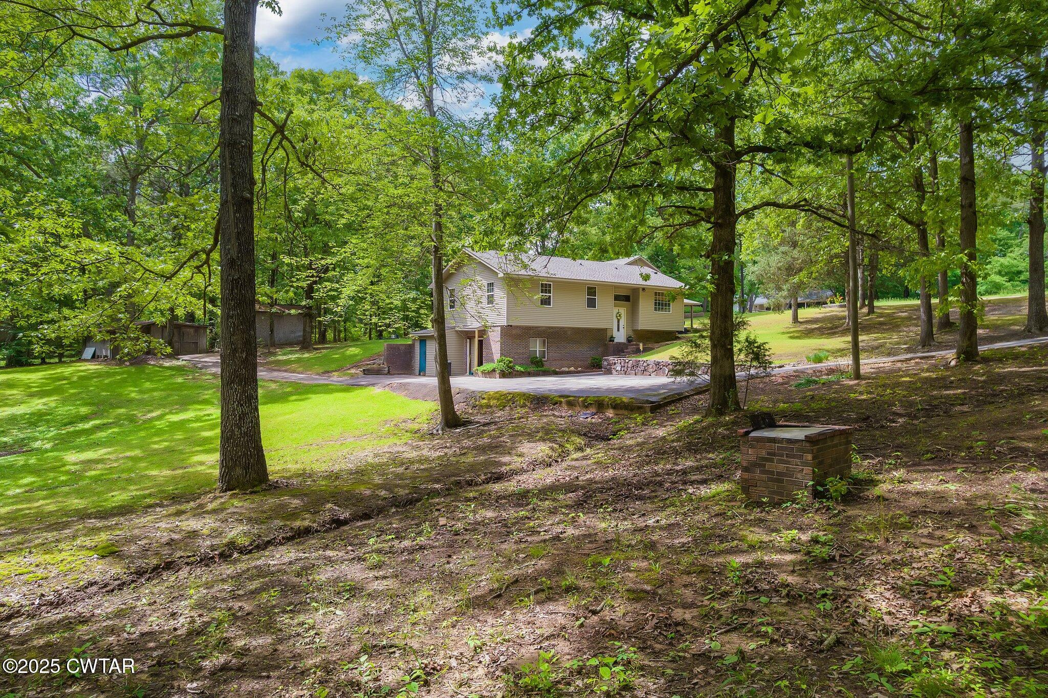 480 Roby Road Reagan, TN 38368 - Photo 3 of 38 a view of a house with backyard and a tree