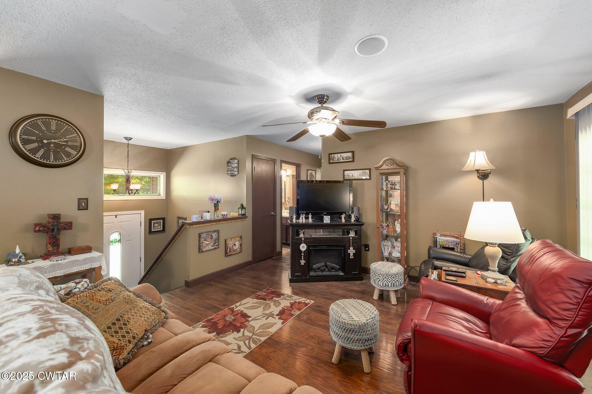 480 Roby Road Reagan, TN 38368 - Photo 5 of 38 a living room with furniture a dining table and a fireplace