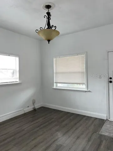 a view of a room with wooden floor and windows
