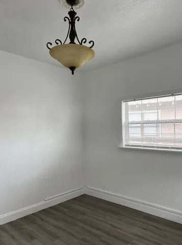 a view of a room with wooden floor and window