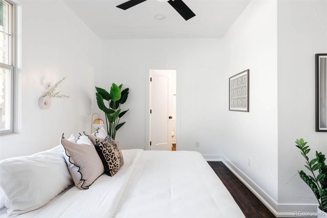 a bedroom with a bed and a potted plant