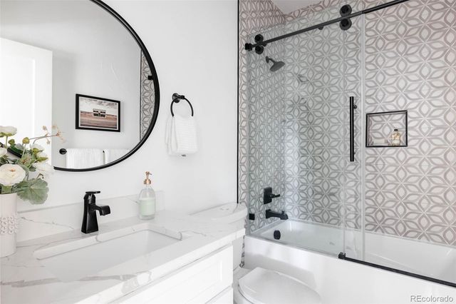 a bathroom with a sink a toilet and bathtub