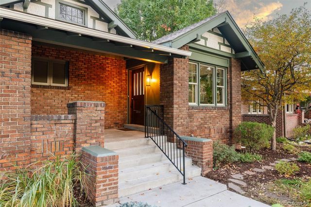 a front view of a house with iron fence
