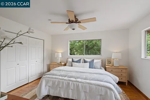 a bedroom with a large bed and a window