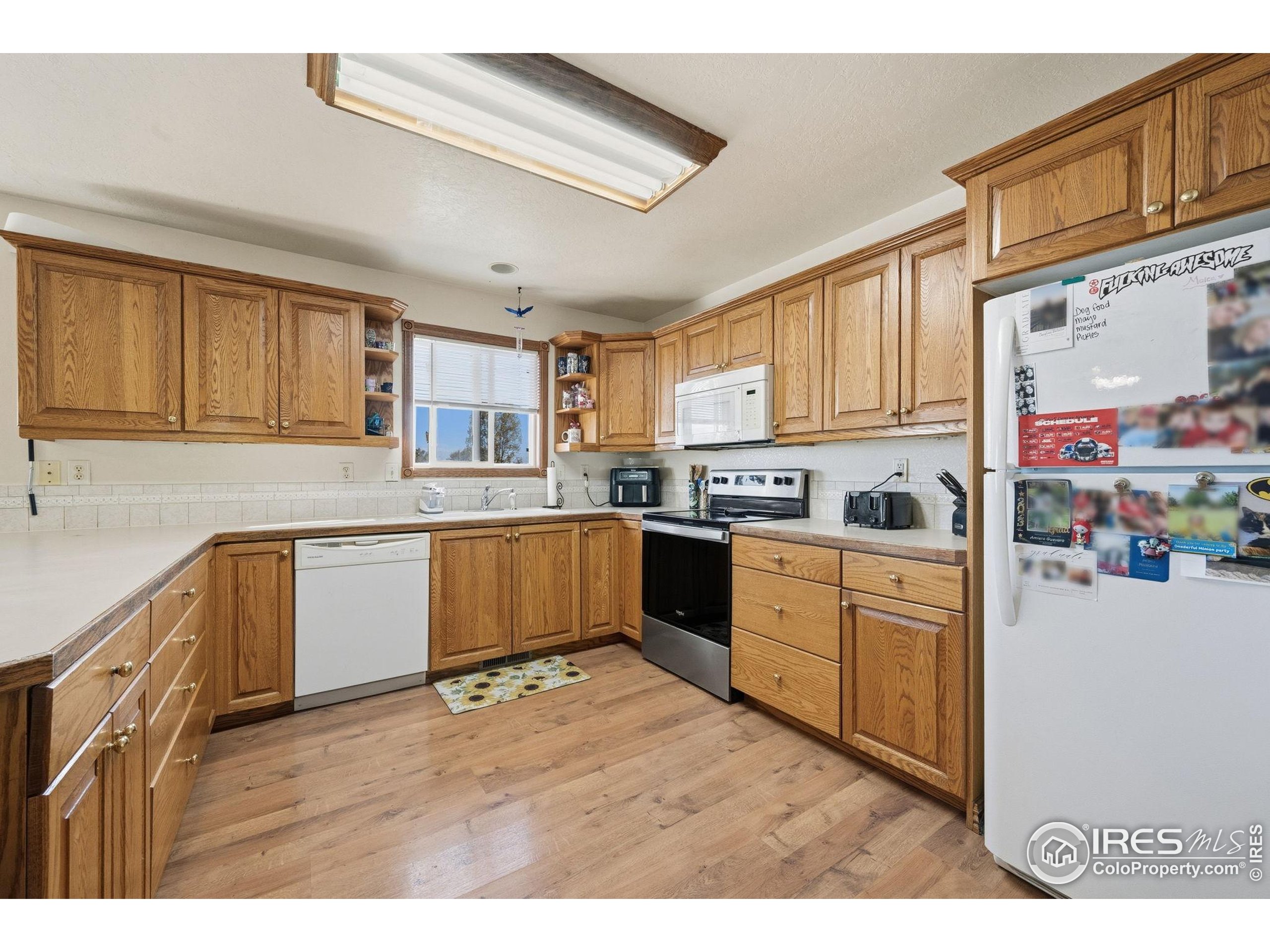 3340 35th Street Greeley, CO 80634 - Photo 4 of 10 a kitchen with stainless steel appliances granite countertop a stove sink and cabinets