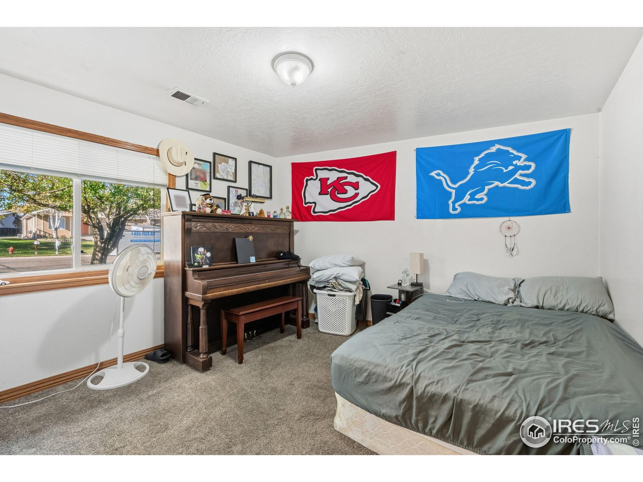 3340 35th Street Greeley, CO 80634 - Photo 8 of 10 a bedroom with a bed and a window