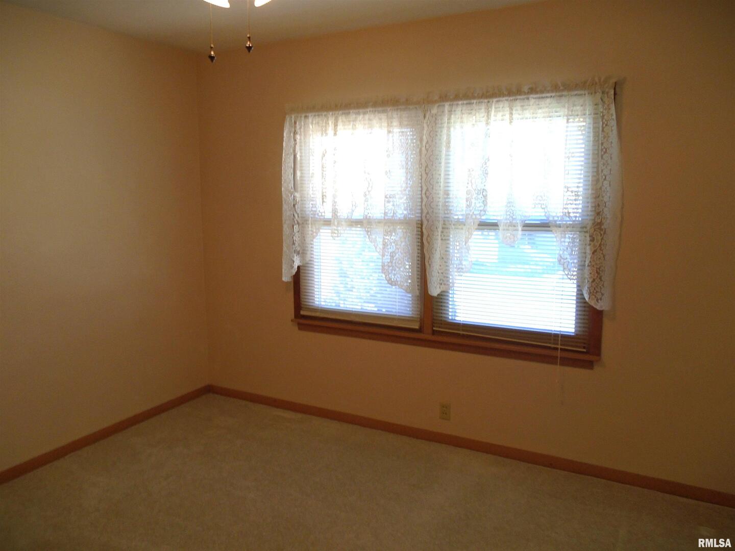 702 High Street Dixon, IA 52745 - Photo 11 of 16 an empty room with a window