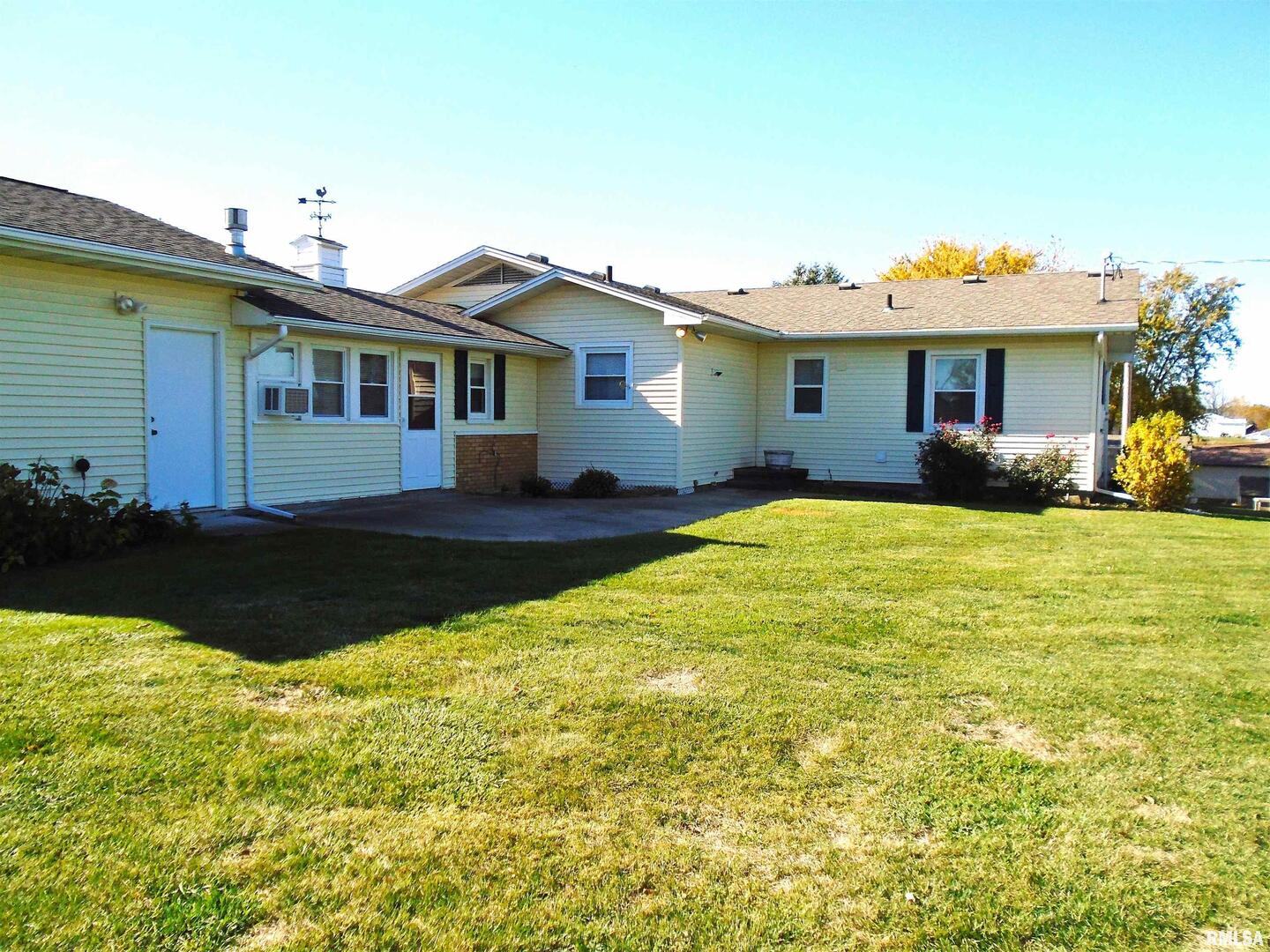 702 High Street Dixon, IA 52745 - Photo 15 of 16 a front view of a house with a garden