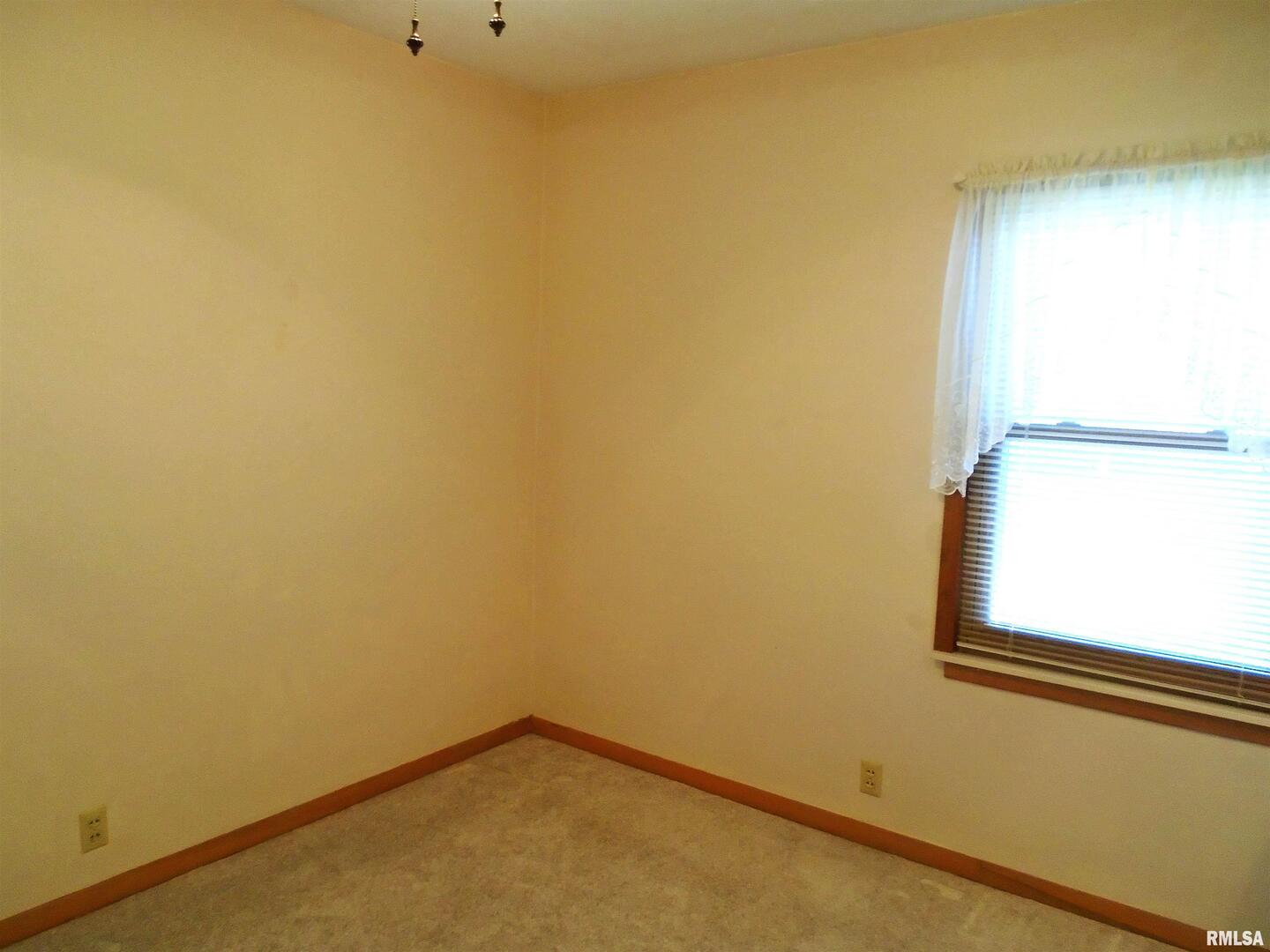 702 High Street Dixon, IA 52745 - Photo 9 of 16 a view of a small space with a window