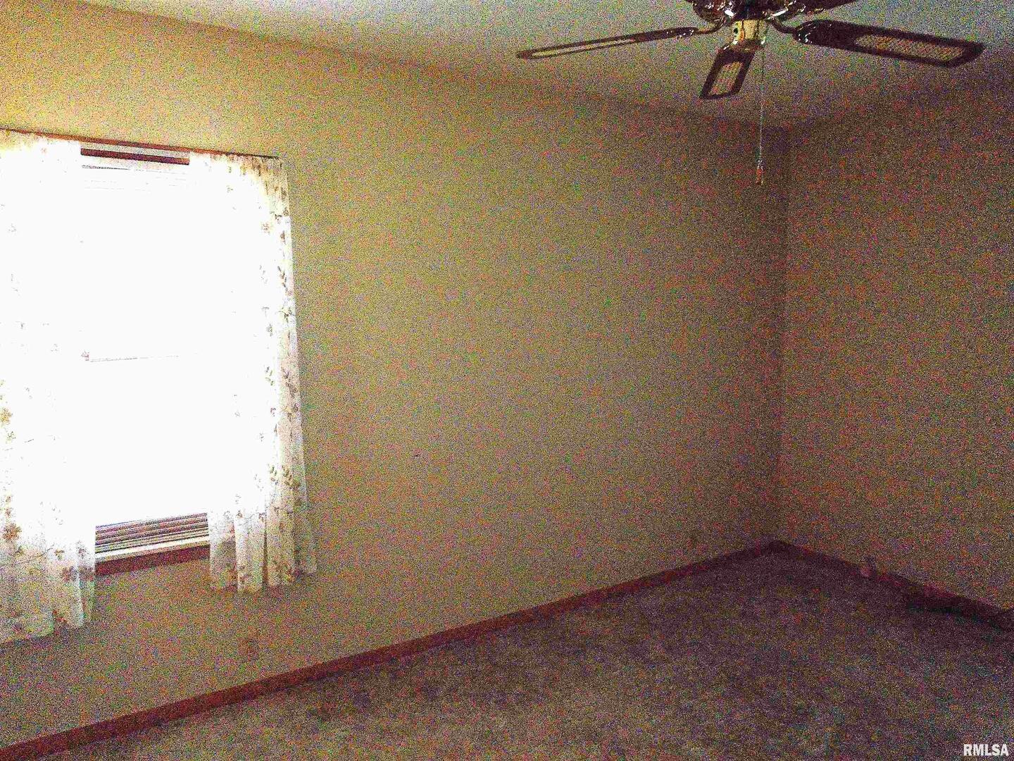 702 High Street Dixon, IA 52745 - Photo 10 of 16 an empty room with a window