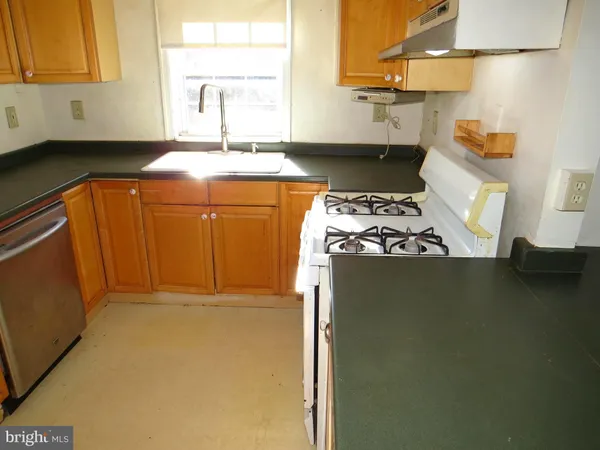 a kitchen with a refrigerator a sink and cabinets