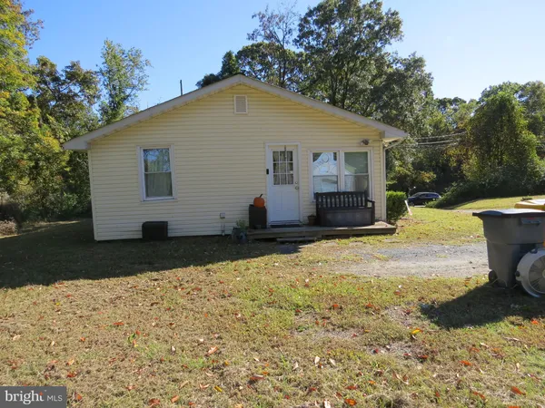 a view of a blue house with a yard