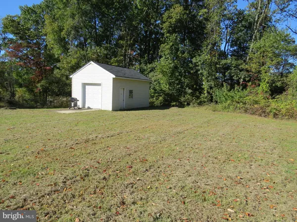 a view of yellow house with a yard