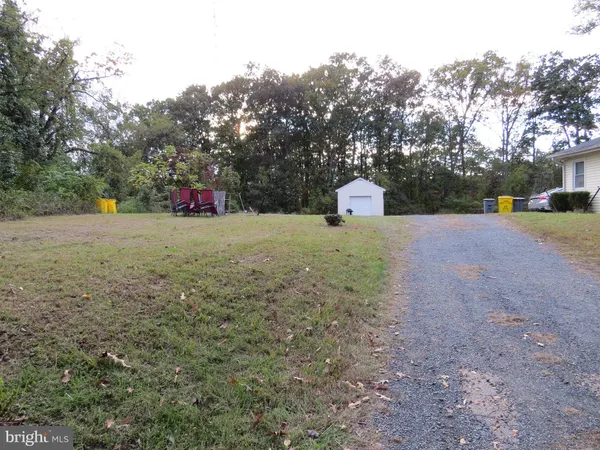 a view of a field with trees in the background