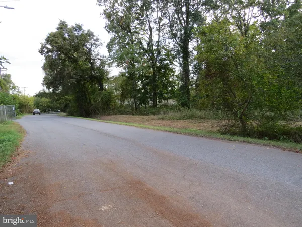 a view of a field with trees in background