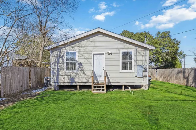 a view of a backyard with wooden fence