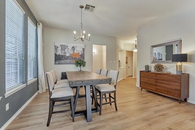 a view of a dining room with furniture window and wooden floor