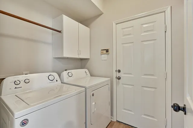 a view of storage and utility room with washer and dryer