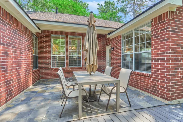a view of a patio with a table and chairs