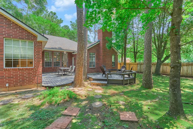 a view of a house with backyard and sitting area