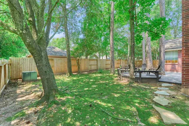 a view of a house with backyard and sitting area