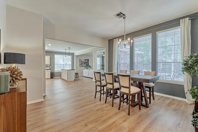 a view of a dining room with furniture window and wooden floor