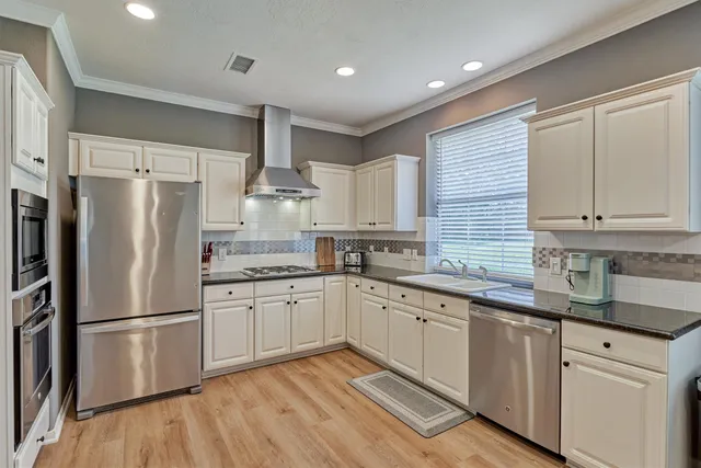 a kitchen with stainless steel appliances granite countertop a refrigerator sink and microwave