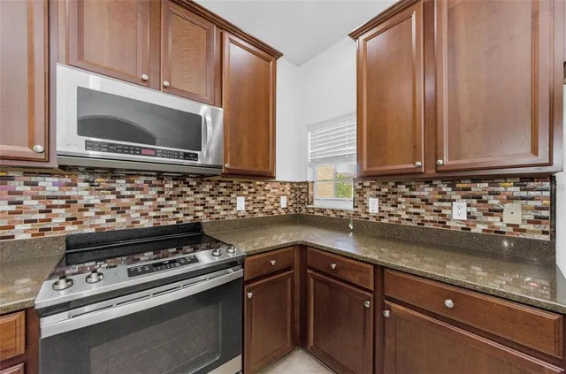 a view of a kitchen with a sink and chandelier