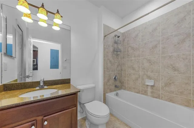 a view of a room with a window and a ceiling fan