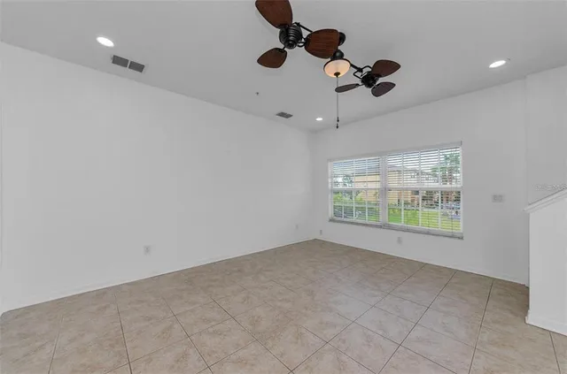 a view of a livingroom with a ceiling fan and window
