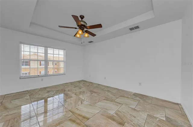 a bathroom with a granite countertop sink a large mirror and a bathtub
