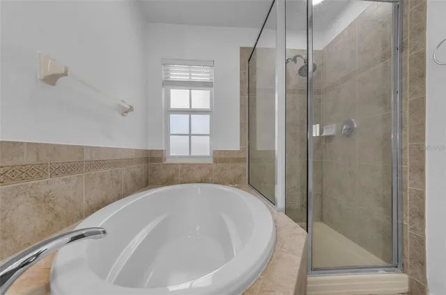 a view of a bedroom with wooden floor