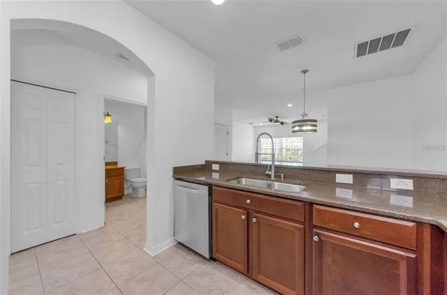 a kitchen with stainless steel appliances granite countertop a sink stove and microwave